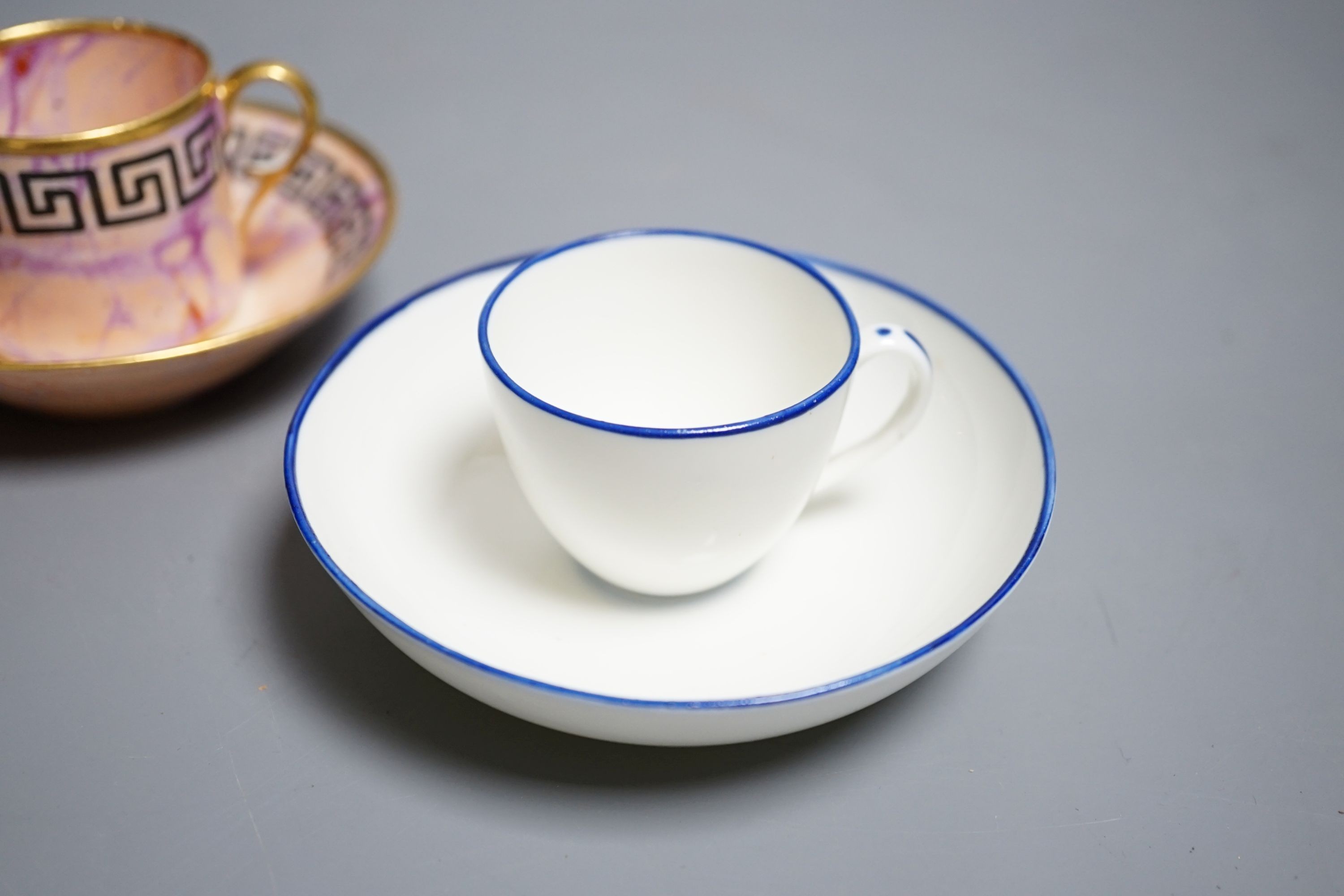 A Derby miniature coffee can and saucer, c.1800-10 and a Pinxton miniature teacup and saucer, c.1800. Provenance - Mona Sattin collection of miniature cups and saucers, collection no.s 112 & 114.